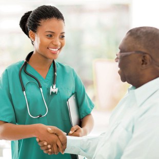 nurse shaking hands with older patient