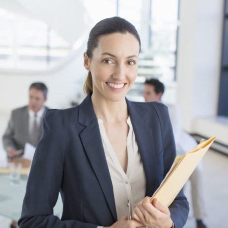 smiling professional woman holding file folder