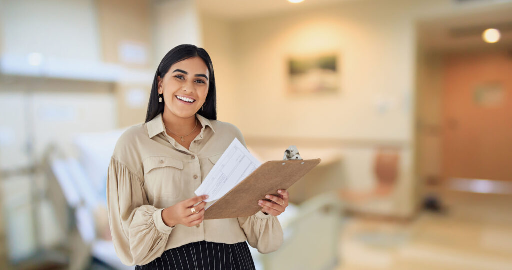 Certified Case Manager reviewing documents on clipboard in healthcare setting, representing CCM continuing education and online CE contact hours with CareerSmart®