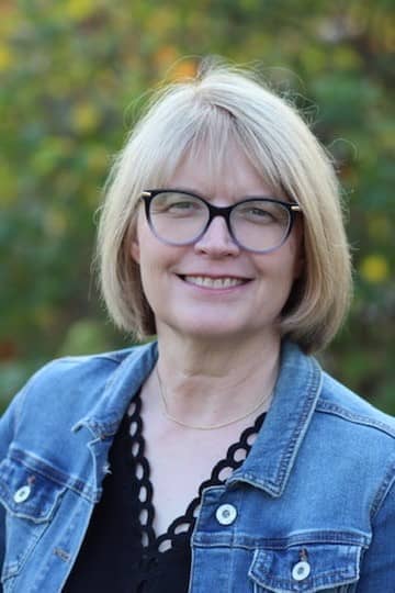 Professional headshot of Alice Blackmore, RN, MN, a healthcare leader and educator, smiling outdoors.