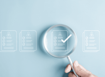 Magnifying glass highlighting a checklist representing continuing education documentation and compliance review in healthcare