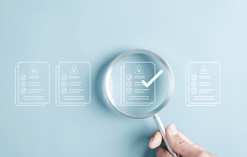 Magnifying glass highlighting a checklist representing continuing education documentation and compliance review in healthcare