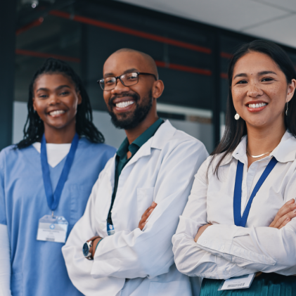 Doctors, group and happy with arms crossed in hospital with confidence in medical goals or mission. Healthcare, team and portrait of people in clinic working in medicare with pride and diversity