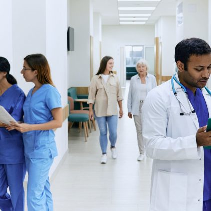 Physicians and clinical staff reviewing patient information and coordinating care in a medical facility.