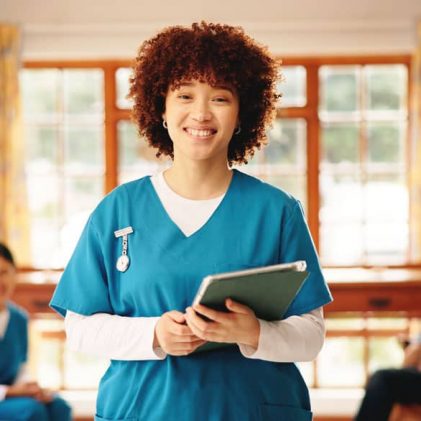 Skilled nursing staff member using a tablet to support resident care, compliance training, and long-term care team development.